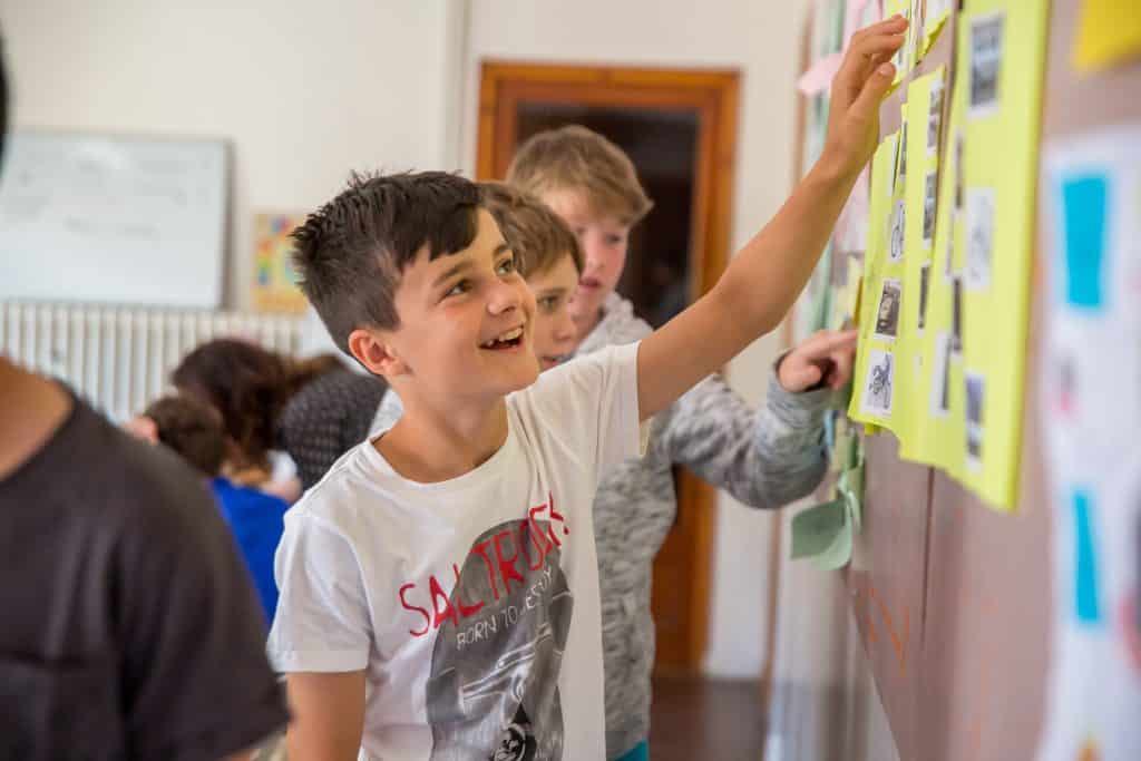 Junior points to pictures in classroom